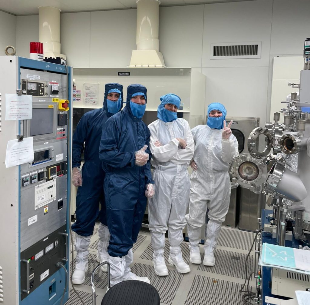 students pose in the cleanroom